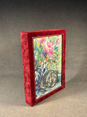 a red book with a picture of a cat and flowers on it