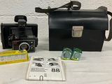 a black bag and a black camera on a table