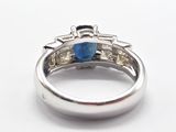 an image of a diamond and sapphire ring on a white surface
