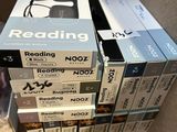 many books stacked on top of each other in a box