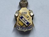 a close up of a badge on a white surface