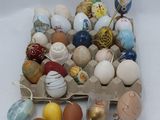 many different colored eggs in a carton on the table