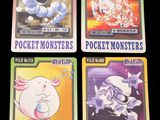 four pokemon cards are shown on a black surface