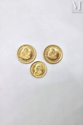 three gold coins with a picture of a man and a woman on them
