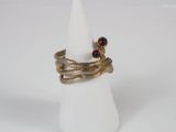 a close up of a gold ring with garnets on it