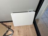an image of a heater sitting on the floor next to a cardboard box