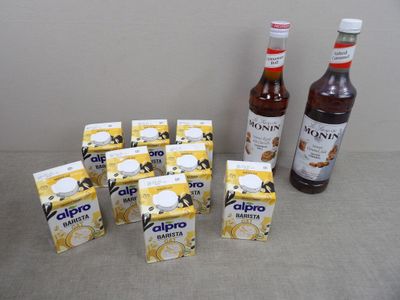 des pots de yaourt et une bouteille de sirop sont posés les uns à côté des autres