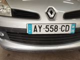 a silver car with a blue license plate on it