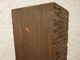 a wooden block that has a carved design on it