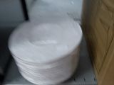 a stack of plates sitting on top of a metal shelf