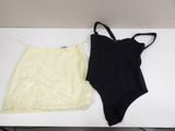 two pieces of black and white swimsuits on a white table