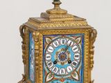 a blue and gold clock sitting on top of a table