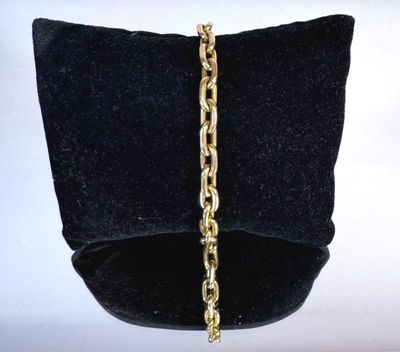 bracelet with a gold chain on a black velvet bag