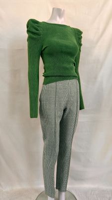 the mannequin is wearing a green sweater and gray pants