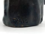 statue of a man with a hat on his head with the word paris written on it