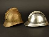two helmets sitting next to each other on a black surface