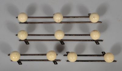 a set of eight wooden ball hooks on a wall