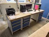 a desk with two computers and a printer on it