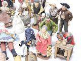 many figurines of people that are sitting on a table