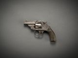 an old revolver on a gray surface with a black background