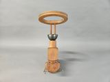 a small wooden table with a metal object on top of it