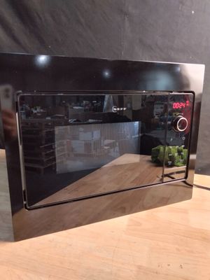 a microwave that is sitting on a table in a room