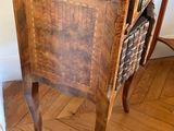 a small wooden table with a basket on top of it
