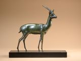 an image of a bronze statue of a gazelle on a wooden base
