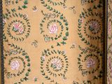 a suitcase with a floral pattern on it sitting on the floor