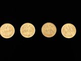 four gold coins are arranged in a row on a black background