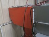a red and gray machine with a hose attached to it