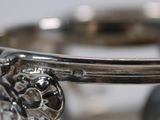 a close up of a silver ring with a flower on it