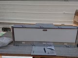 a white box sitting on top of a table next to a brown box