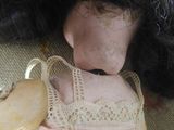 a doll that is sitting on a chair with a wooden shoe