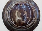 a dirty plate on the wall with a white background
