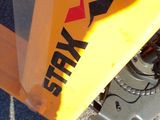 a close up of a fork on the back of a yellow truck
