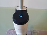 a microscope that is sitting on a table with other items around it