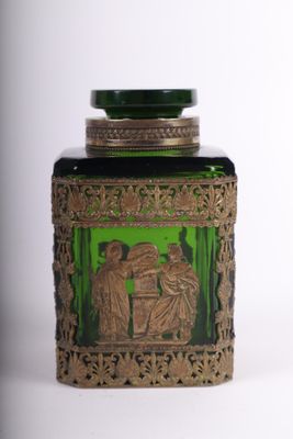 a green glass jar with a picture of a man and a woman on it