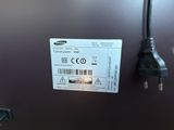 an image of a close up of a samsung power cord plugged into a refrigerator