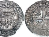 a close up of a coin with a cross on it