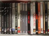 a lot of dvd ' s on a shelf in the room