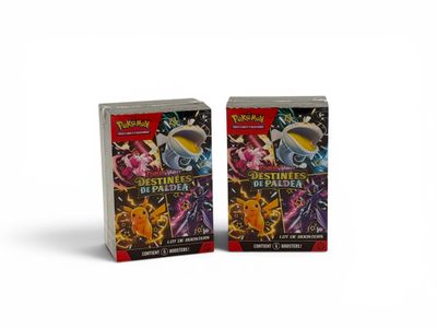 two packs of pokemon trading cards are shown in front of a white background