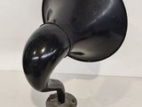 an antique black phonom on a metal stand on a white surface