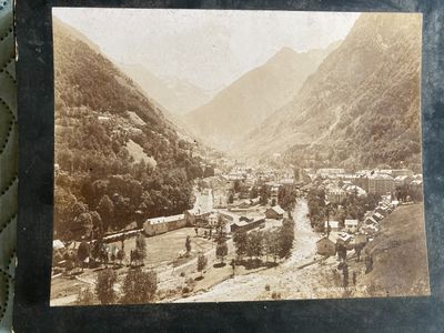 an old photo of a small town in the mountains