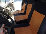 a person sitting in the driver ' s seat of a van