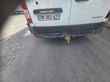 a cat that is sitting on the back of a van