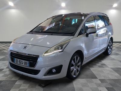 the small white car is parked on a checkered tile floor