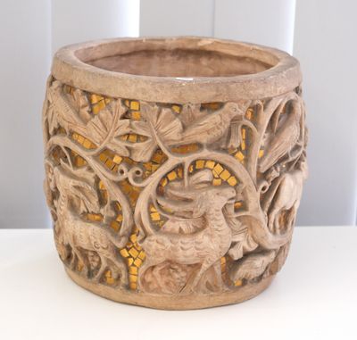 a wooden bowl with carvings on it sitting on a table