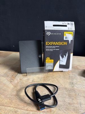 an image of a box of external hard drives sitting on top of a wooden table