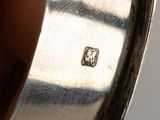 an image of a silver plate with a square diamond on it